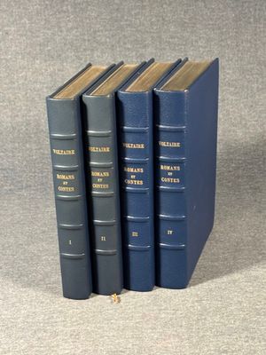 three blue books sitting on top of each other on a table