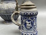 two blue and white vases sitting next to each other