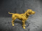 gold dog figurine on a black background with a dark background