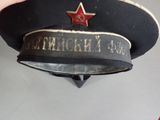 someone is holding a hat with a red star on it