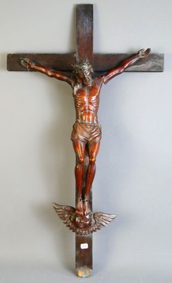 statue of jesus on a cross with a bird on it