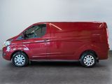 the red van is parked in a room with a white wall