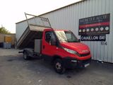 a red truck that is parked in front of a building
