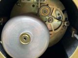 a close up of a clock that is on a table