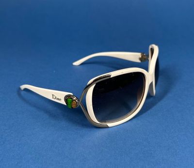 a close up of a pair of sunglasses on a blue surface