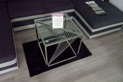 une table basse en verre surmontée d'un porte-revues