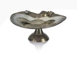a silver plate with a bird on it on a stand