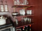 a shelf with wine glasses and wine glasses on it