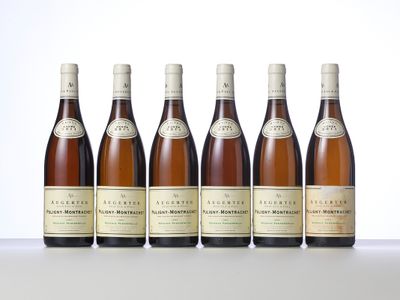 six bottles of wine are lined up on a table