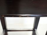 an image of a wooden table with a black top