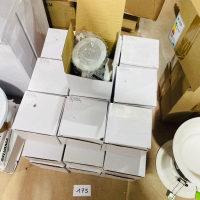 a pile of white boxes and a toilet in a room
