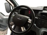a car dashboard with a steering wheel and a dash light
