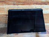 a black tablet computer sitting on a wooden table