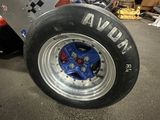 a close up of a tire on a race car in a garage