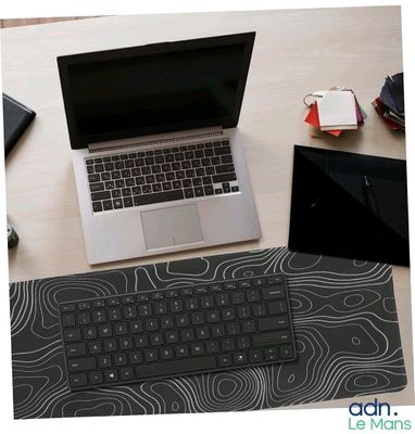 a laptop computer sitting on a desk with a mouse and keyboard