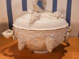 a white bowl with a lid sitting on a wooden table