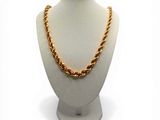 necklace on a mannequin with a gold chain on a white mannequin