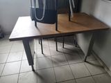 a desk with a chair and a lamp on top of it