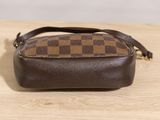 a brown and black purse sitting on top of a wooden table