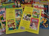 a lot of comic books that are on the table