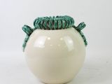 white ceramic vase with green rope wrapped around the top