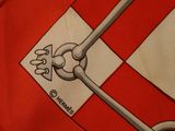 a close up of a red and white shirt with a flag on it