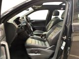 the interior of a car with the door open showing the driver ' s seat area