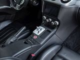 the interior of a black sports car with a steering control