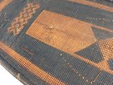 a brown and black rug with a design on it