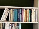 many books that are on a shelf in the room