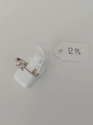 a small white object with a gold ring on it
