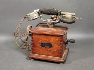an old fashioned telephone that is on display on a table