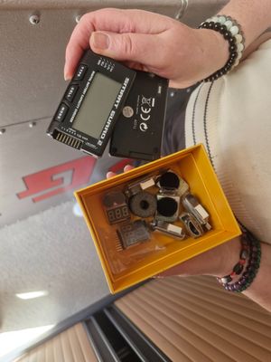 a person holding a small electronic device in a yellow box