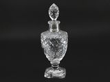 an image of a clear glass perfume bottle on a black background