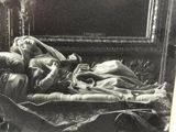 a black and white photo of a woman laying on a bed