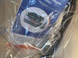 a bag of electronics sitting on the seat of an airplane