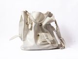 beige leather handbag on a white background with a white background
