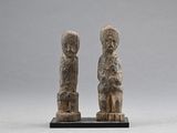 pair of stone figurines of a man and a woman