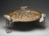 a metal tray with birds on it on a table