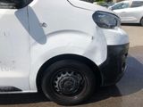 a white van that has been vandalized and is parked in a parking lot