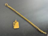 a close up of a gold plated bracelet with a tag on it