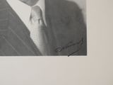a black and white photo of a man in a suit and tie