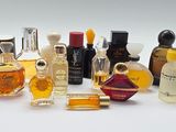 a lot of different types of perfume bottles on a white surface