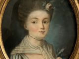 portrait of a lady with a flower in her hair in a gold frame