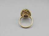 a gold ring with an emerald stone center