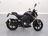 a black motorcycle that is parked on a white floor