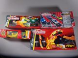 three toy cars are sitting on a table next to each other