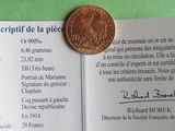 a penny sitting on top of a piece of paper on a table