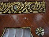 a wooden clock with a gold decoration on it