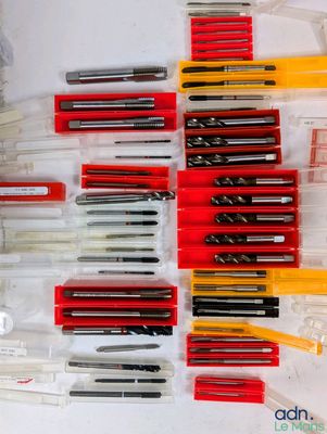 many different pens and pencils laid out on a table